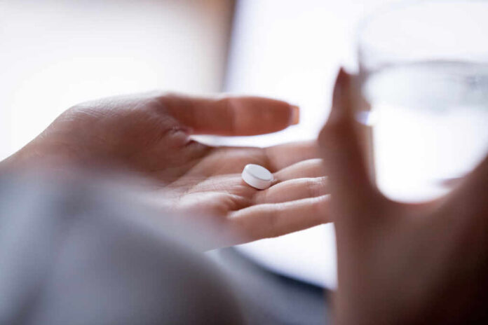 Close,Up,Woman,Holding,Pill,In,Hand,With,Water.,Female
