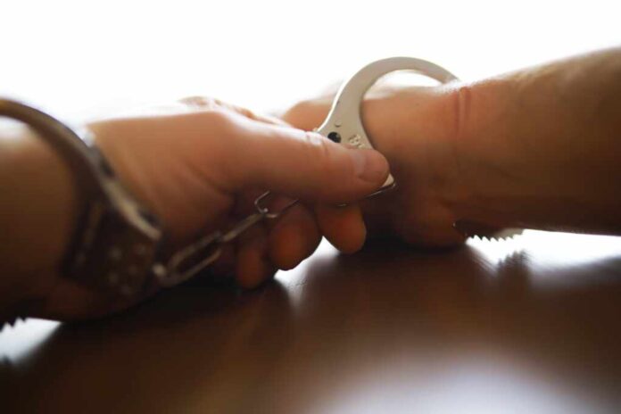 Police,Officer,Handcuffing,A,Suspect,-,Close-up,Of,Hand,And