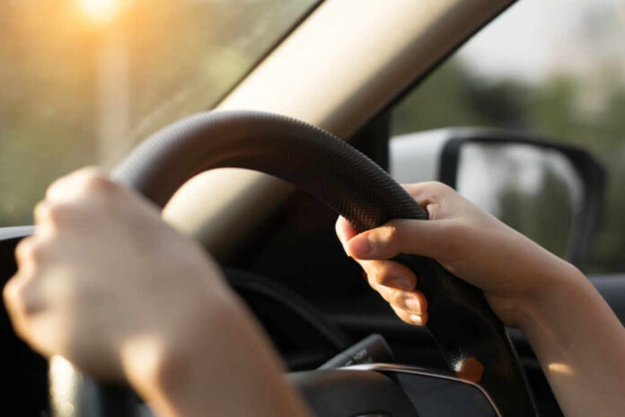 Female,Hands,On,The,Steering,Wheel,Of,A,Car,While