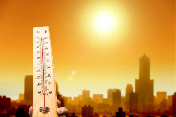 Heat,Wave,In,The,City,And,Hand,Showing,Thermometer,For