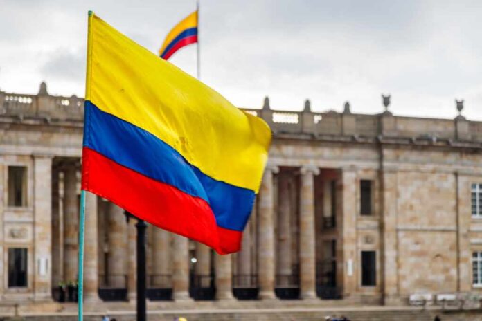Close,Up,Of,Colombian,Flag,With,Parliament,Building,In,Background