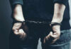 A person in handcuffs with their hands behind their back