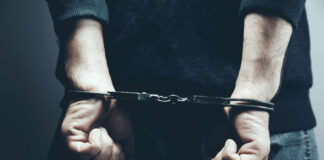 A person in handcuffs with their hands behind their back