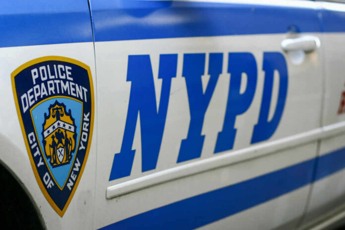 Close-up of a New York Police Department vehicle with badge and NYPD lettering