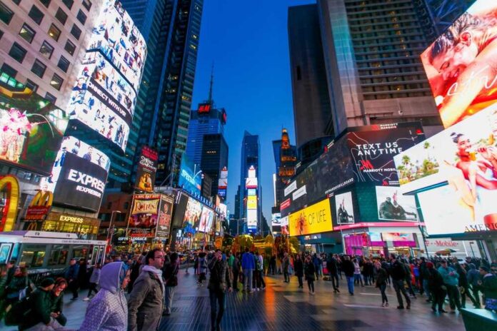 Crowd of people in Times Square surrounded by bright advertisements and buildings