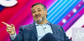 A man in a suit speaking at a conference