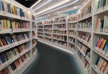 Interior view of a modern library with bookshelves filled with colorful books