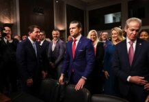 A group of individuals in formal attire at a congressional hearing