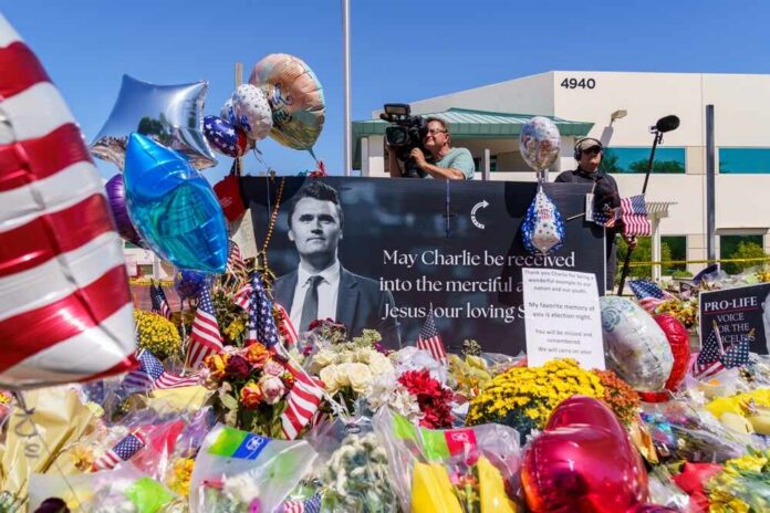 shutterstock_2679352913.jpg A memorial site with flowers, balloons, and a large photo honoring Charlie