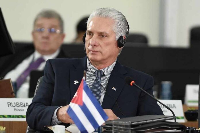 shutterstock_2691843245.jpg Cuban leader at a political meeting wearing headphones
