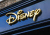Golden Disney logo on a dark blue storefront