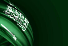 Saudi Arabian flag with white script and sword on a green background