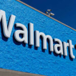 Walmart store sign against a bright blue wall
