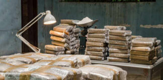 Stacks of packaged goods in a dimly lit warehouse