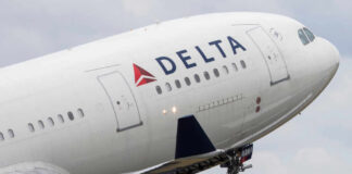 Premium Flyers Shield Delta From Economic Storms Close-up of a Delta Airlines airplane during takeoff