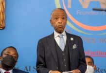 Harris Donation Bombshell: Sharpton Under Fire A speaker at a press conference addressing an audience