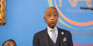 A speaker at a press conference addressing an audience