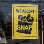 Sign in a store window indicating acceptance of SNAP benefits