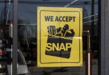 Sign in a store window indicating acceptance of SNAP benefits