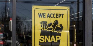 Illegal SNAP Trade: Boston Shop’s Dark Secret Sign in a store window indicating acceptance of SNAP benefits