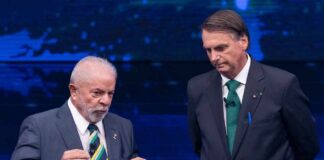 Two Brazilian political leaders engaged in a debate on stage