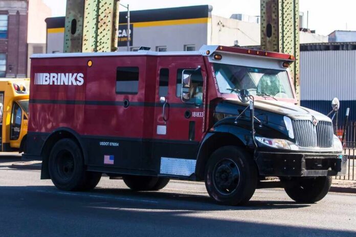 A red and black Brinks armored truck parked on a city street