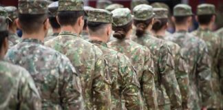 Line of soldiers in camouflage uniforms standing in formation