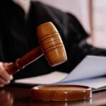 Obama Judge HALTS Trump Energy Crackdown A judges gavel poised above a wooden block with a document in the background