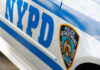NYPD Officer Jailed — Cooler Throw Kills Suspect Close-up of a New York Police Department vehicle showcasing the badge and blue stripes