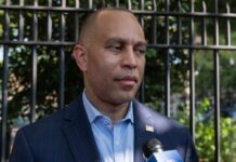 A political figure speaking to the media outdoors