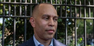 A political figure speaking to the media outdoors