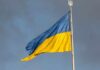 Ukrainian flag waving against a cloudy sky
