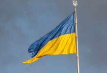Ukrainian flag waving against a cloudy sky