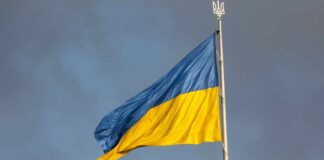 Robotic Revolution: Ukraine’s Machines on the Frontline Ukrainian flag waving against a cloudy sky