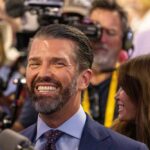 A smiling man in a crowd at an event