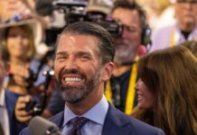 A smiling man in a crowd at an event