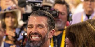 A smiling man in a crowd at an event