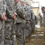 Military Secrets for Sale? Green Beret Turned Classified Intel Into CASH A line of soldiers in military uniforms standing outdoors in formation