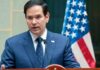 Rubio Warns – NATO’s Future in Jeopardy Marco Rubio speaking at a podium with an American flag in the background