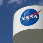 NASA logo on a water tower against a blue sky