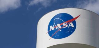 NASA logo on a water tower against a blue sky