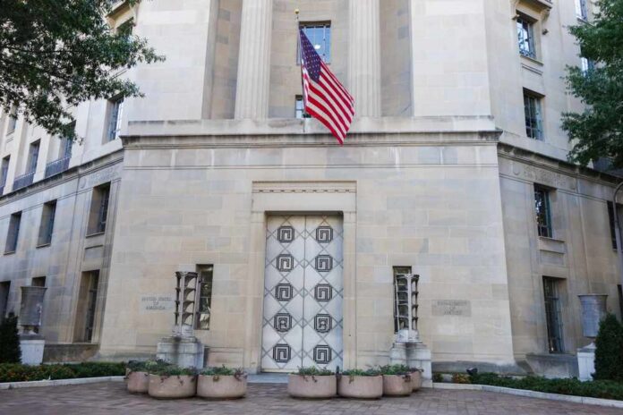 Facade of a government building featuring the American flag and decorative entrance