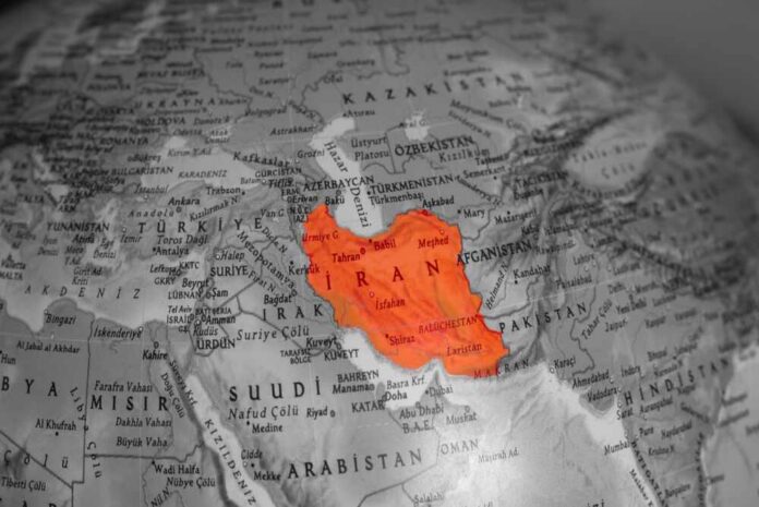 Map highlighting Iran in orange on a grayscale background