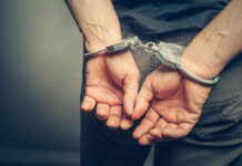 Killer Baker’s DARK Secrets: Chilling Confession! Hands cuffed behind the back, symbolizing arrest