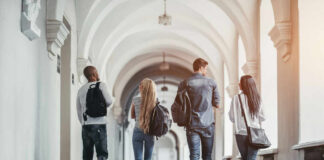 Group of students walking together in a university hallway