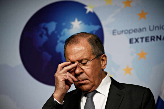A political figure with a serious expression during a press conference