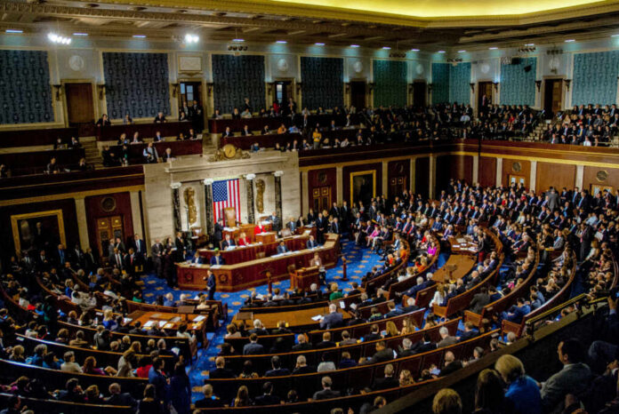 shutterstock_1186368262 A large gathering of officials in a congressional chamber during a legislative session