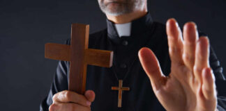 Outrage! Can Exorcisms Really Be Taxpayer Funded? A doctor holding the hand of an elderly patient during a consultation