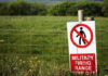 A warning sign indicating a military firing range with a no entry symbol