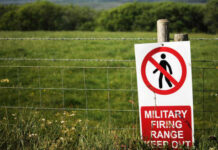 A warning sign indicating a military firing range with a no entry symbol